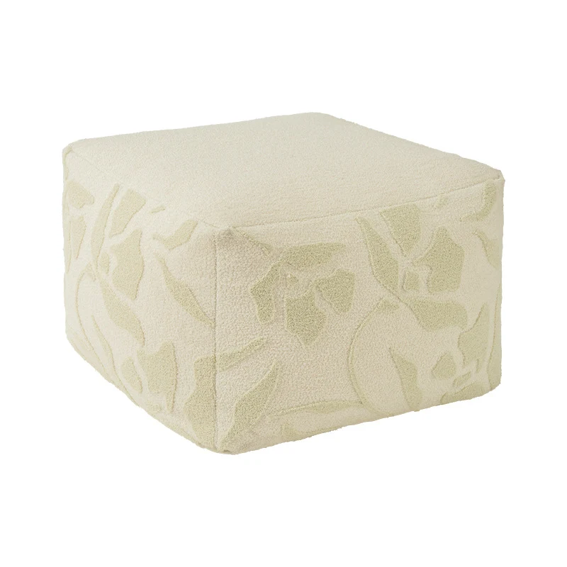 Quadratischer Bodensitzpouf mit strukturierter Bouclé‑Oberfläche und floralem Relief