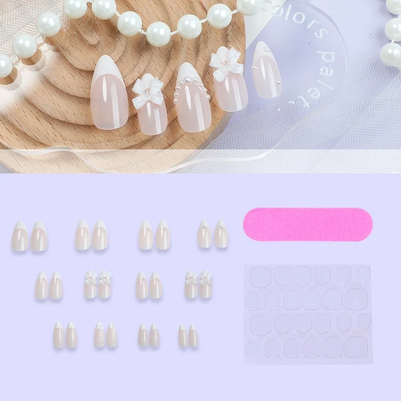 Kreatives Kunstnagelset mit eleganten Schleifen und Perlenelementen Karnz