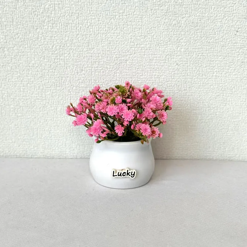 Lebensnahe Miniatur-Blumenarrangement im Topf