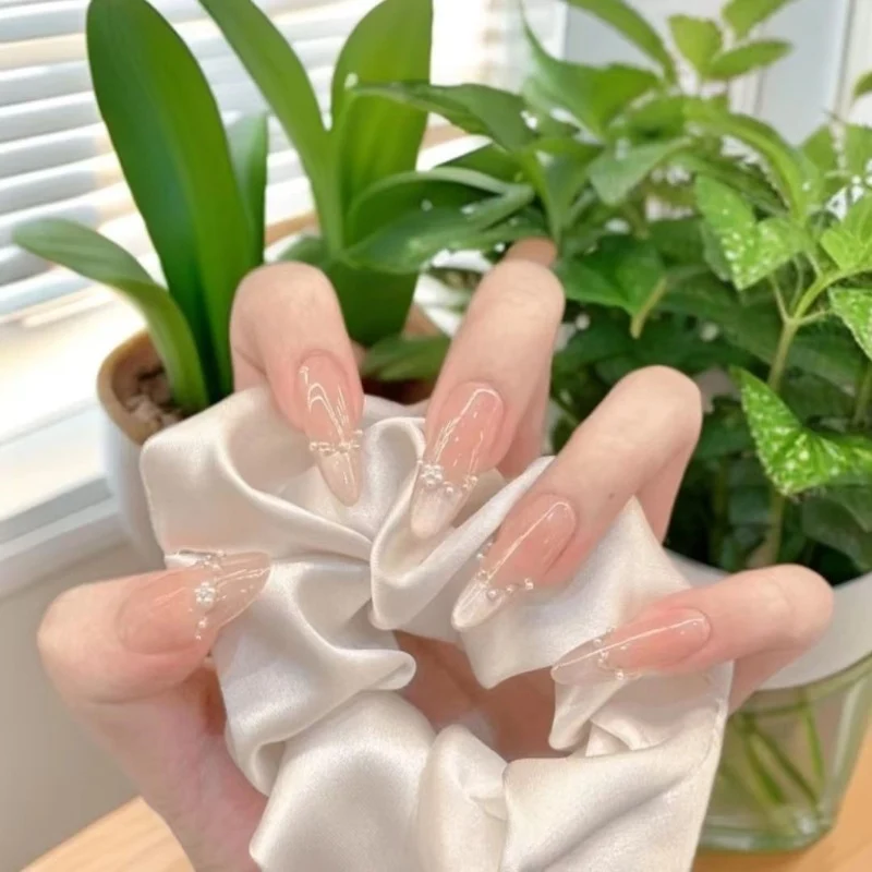 Dekorative Acryl-Nagelerweiterungen mit perlmuttartigen Akzenten