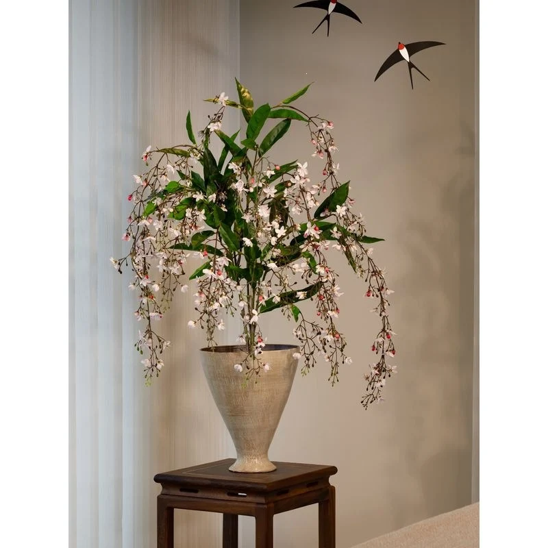 Lebensechte künstliche Blumenarrangement in dekorativem Topf