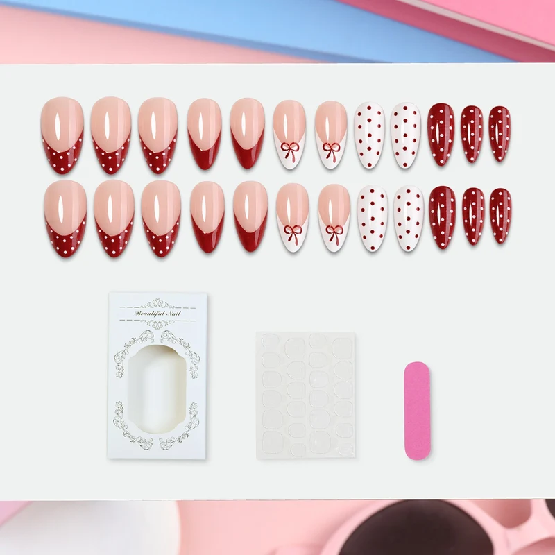 Kunstnagelset mit eleganten Schleifen- und Punkten Karnz